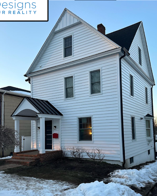After — colonial home with new white vinyl siding and black shutters in Clifton, NJ